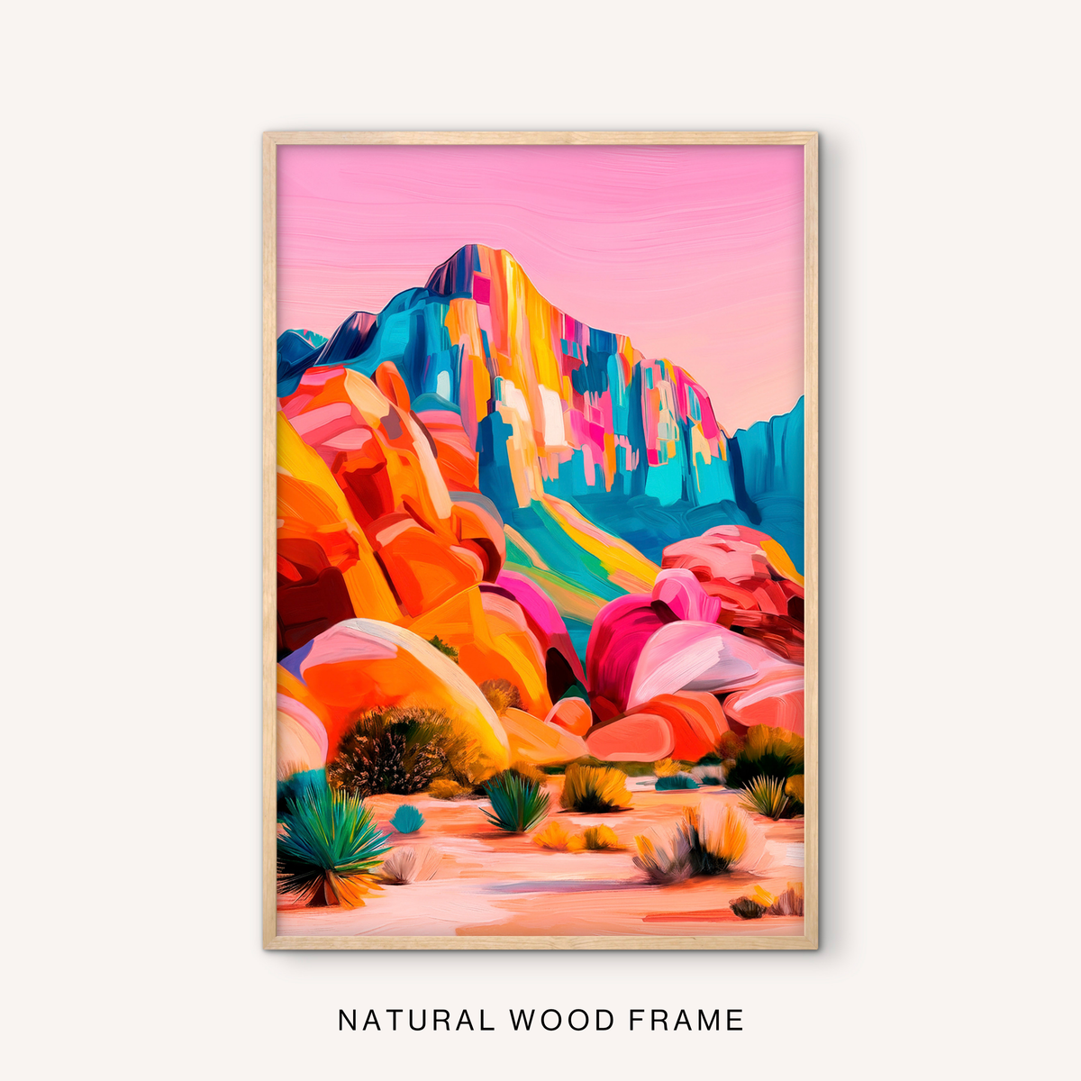 Boho desert canyon wall art in a natural wood frame with colorful mountain scenery, warm southwest rocks, desert plants, and a soft pink sky.