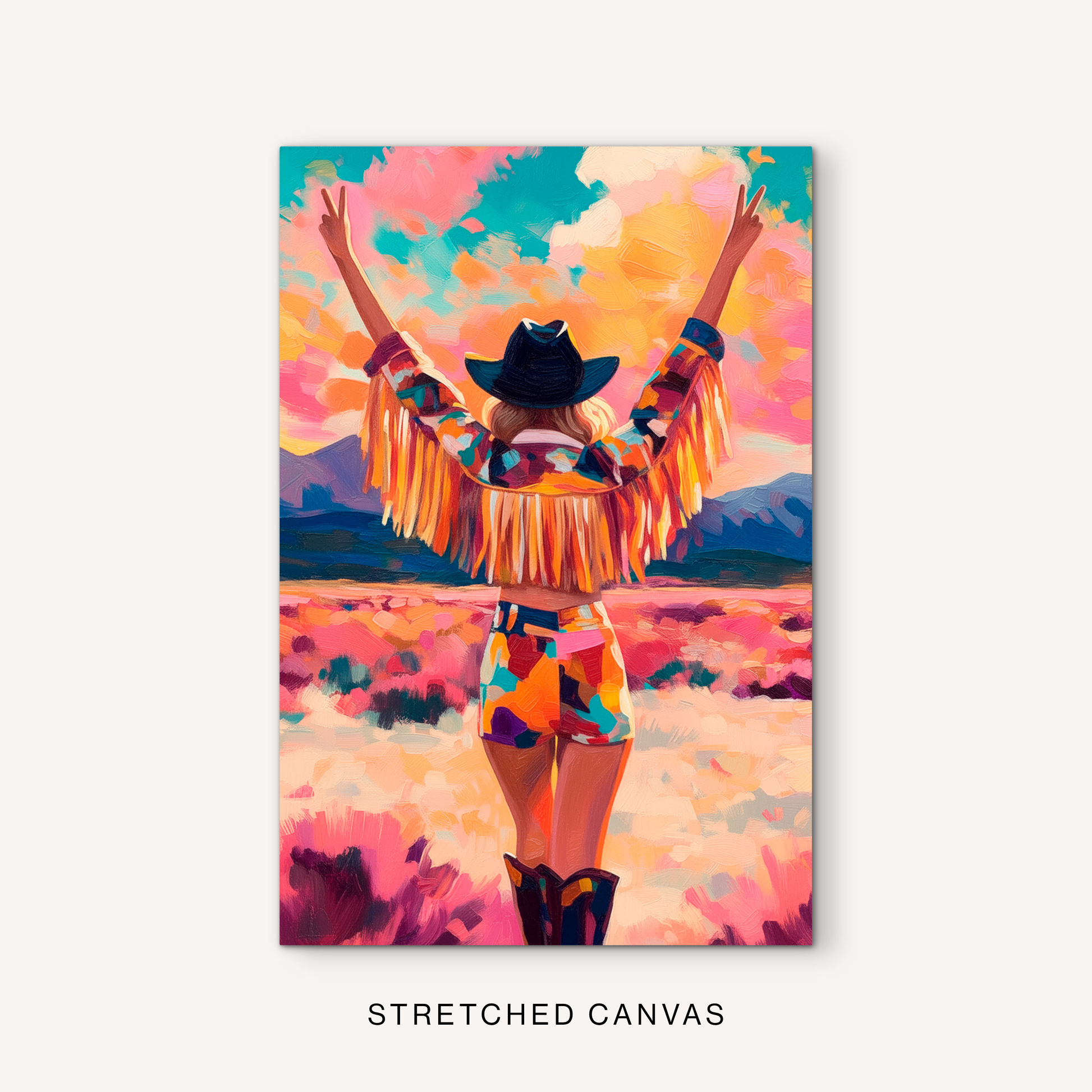 Boho cowgirl canvas art with colorful western style, raised peace signs, fringe sleeves, black hat, and a vibrant pink desert backdrop.