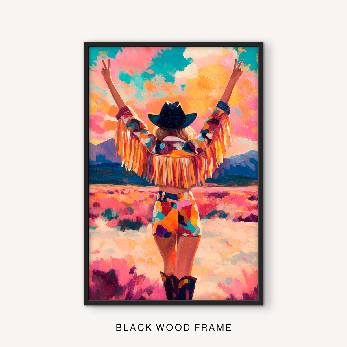 Bold western cowgirl print in a black frame featuring a colorful desert scene, fringe jacket, black cowboy hat, and mountain landscape.