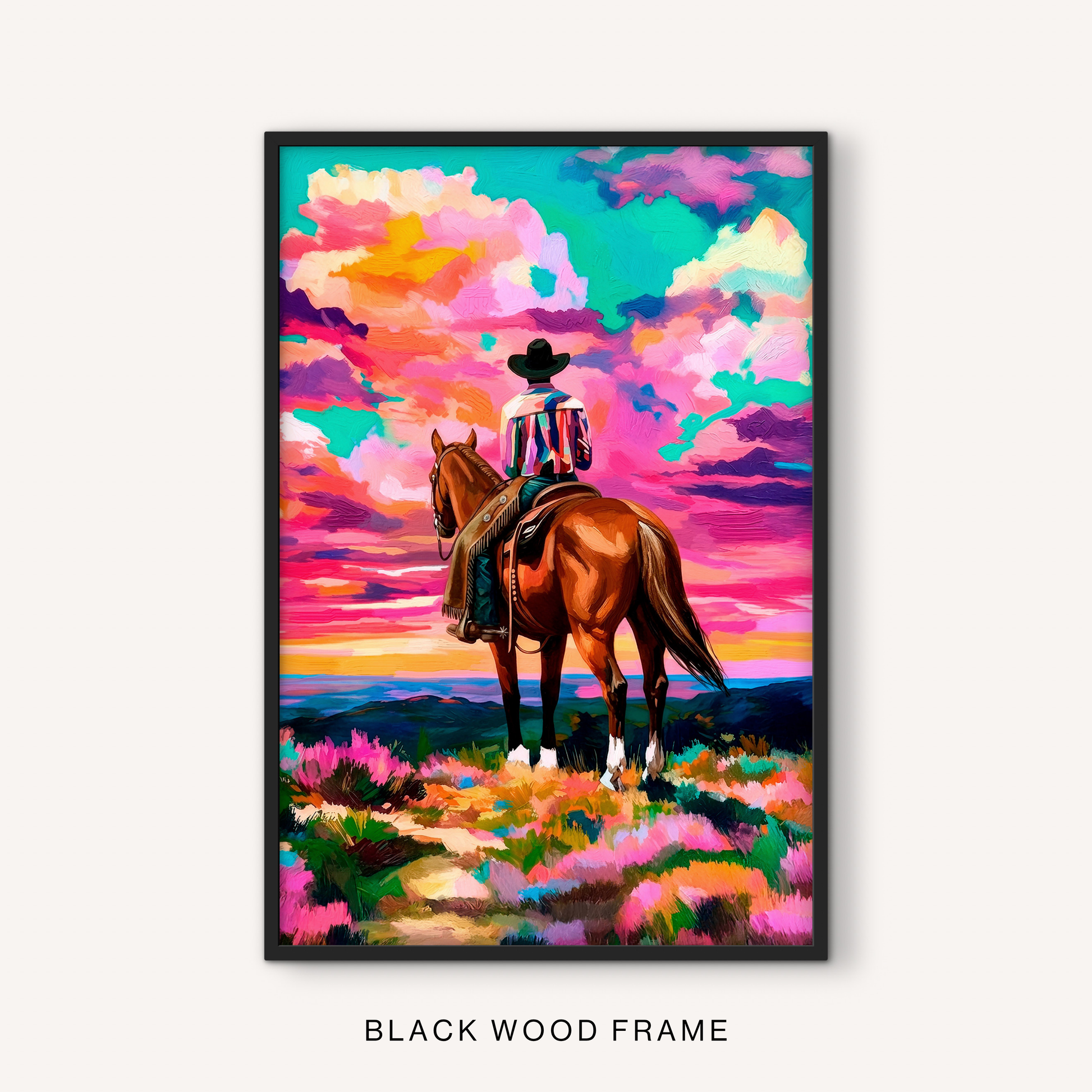Bold western horse print in a black frame featuring a cowboy rider, dramatic sunset clouds, mountain landscape, and colorful ranch scenery.