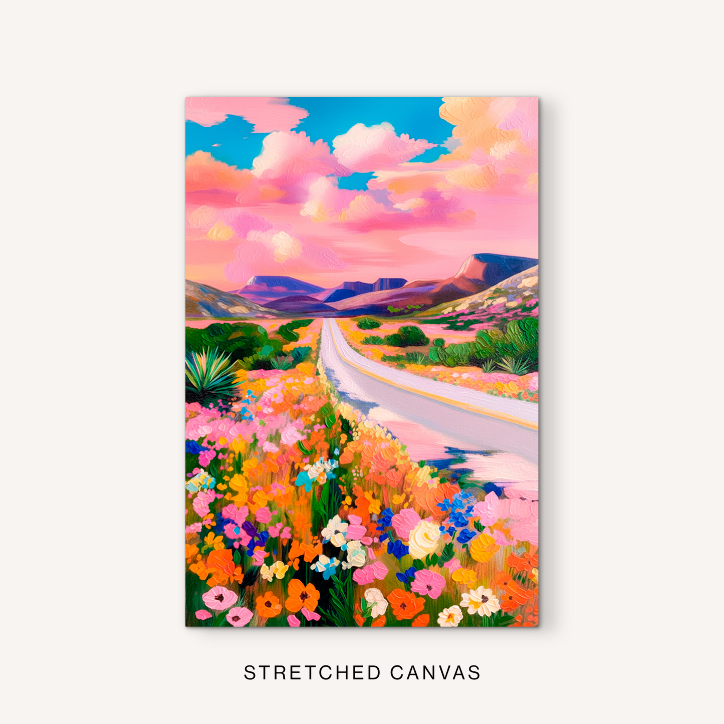 Bright western desert landscape canvas art featuring a pink sky, colorful wildflowers, distant mesas, and an open road.