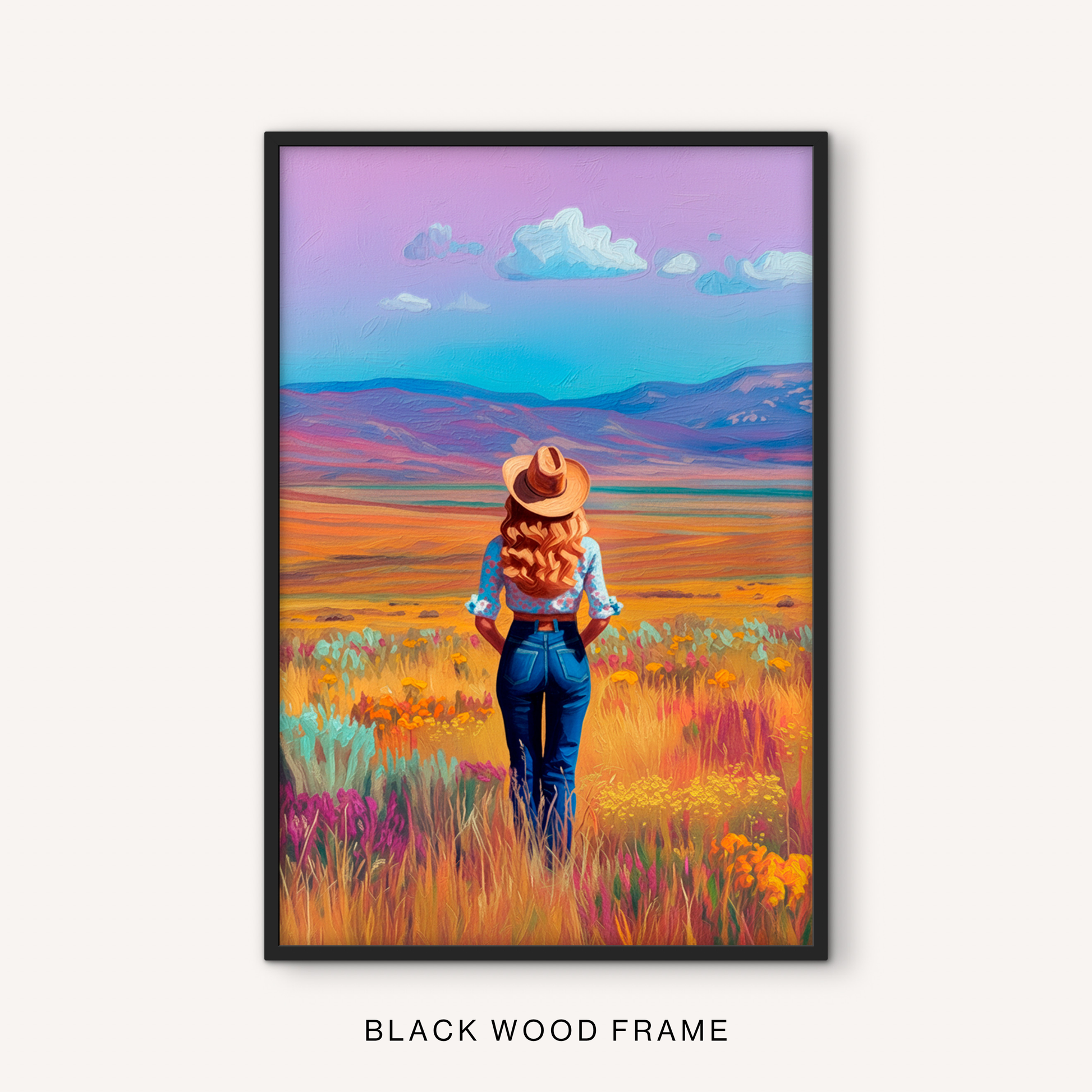 Rustic western cowgirl print in a black frame featuring a colorful prairie landscape, wildflower field, distant mountains, and ranch-inspired style.