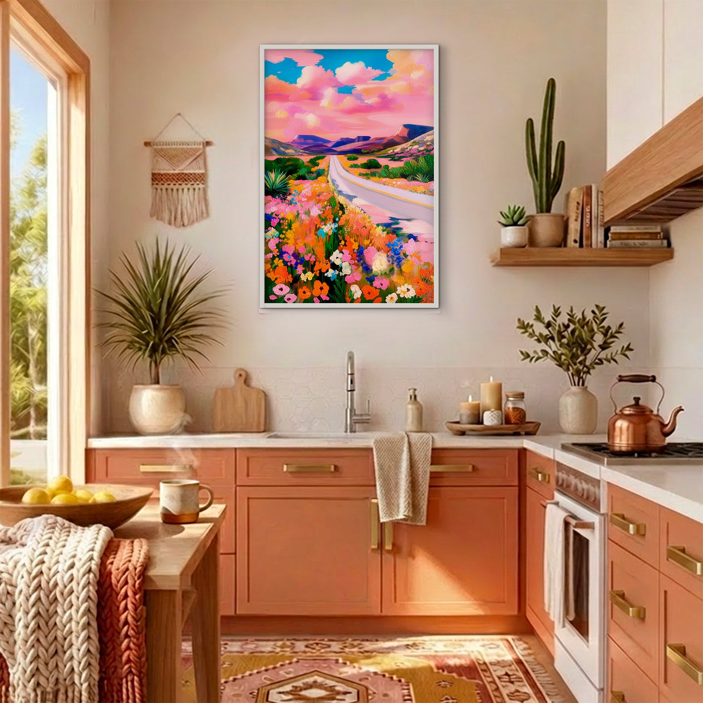 Vibrant mountain landscape print styled in a bright southwestern kitchen with coral cabinets and natural wood accents.