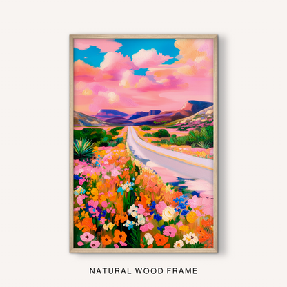 Southwestern mountain wall art in a natural wood frame featuring colorful blooms and an open desert road.