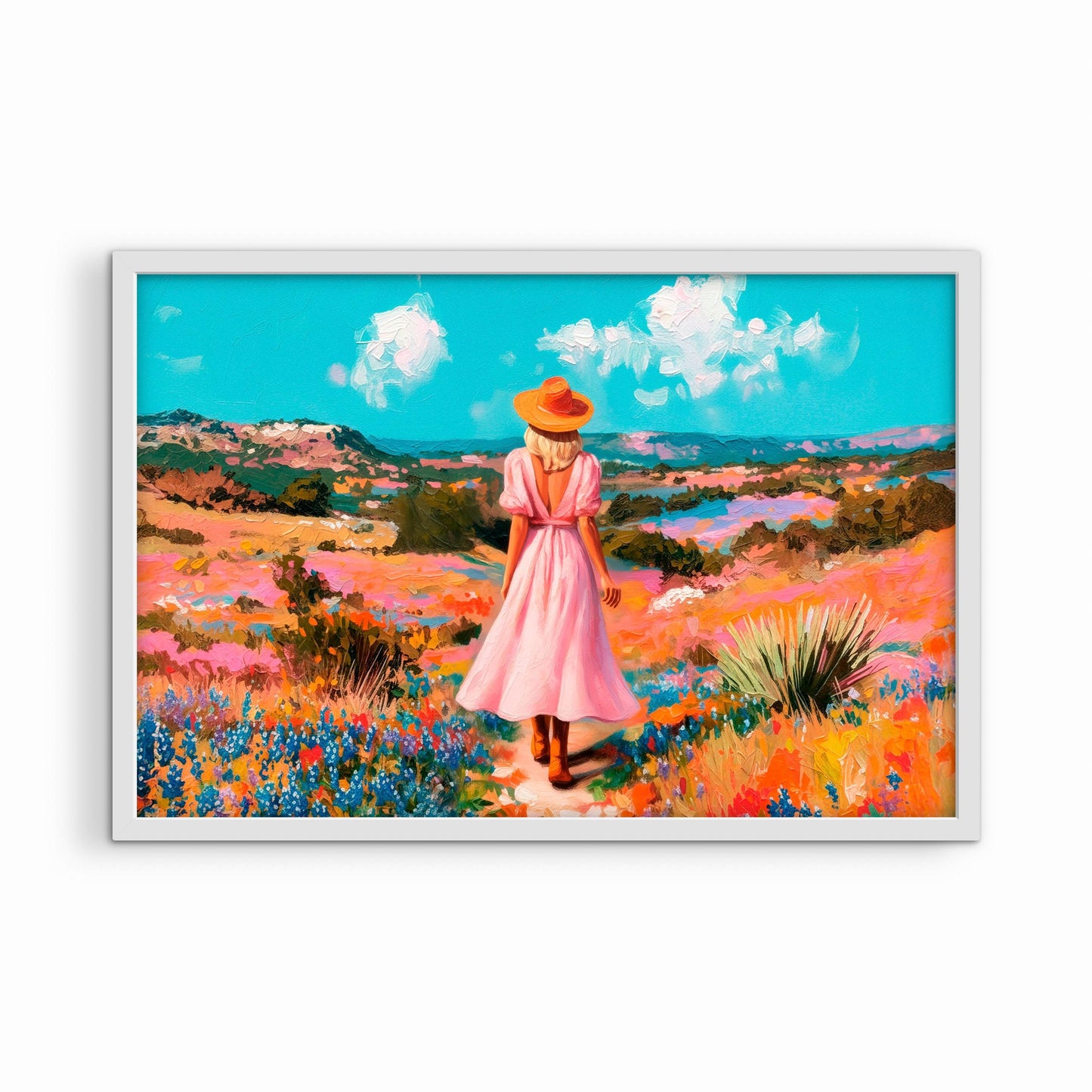 Colorful western wall art in a white frame featuring a woman in a pink dress walking through a vibrant wildflower landscape
